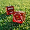 Golf dice with golf-related text on a golf course